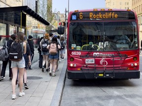 File photo: OC Transpo passengers board a bus on Rideau Street.