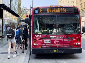 OTTAWA -- OC Transpo passengers board a bus on Rideau Street
