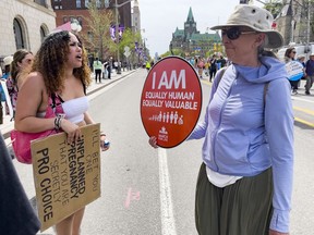 A pro-choice advocate debates with a participant in the March for Life in downtown Ottawa on Thursday, May. 12, 2022.