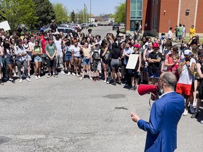 Jason Dupuis, superintendent of education for the French Catholic School Board, speaks to students of Béatrice-Desloges Catholic High School Friday, while they protest the implementation of a dress code.