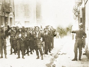 Canadian and Allied soldiers are paraded as prisoners of war by their captors following the 1942 Dieppe Raid.