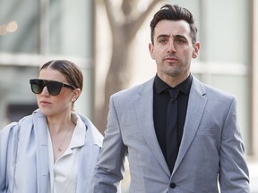 Canadian musician Jacob Hoggard arrives alongside his wife, Rebekah Asselstine, for his sex assault trial at the Toronto courthouse on Tuesday, May 10, 2022.