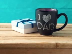 Happy Father's day concept with coffee mug and gift box over wooden background