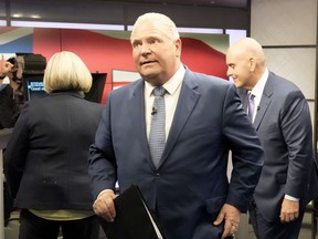 With NDP Leader Andrea Horwath and Liberal Leader Steven Del Duca behind him, Ontario PC Leader Doug Ford departs the Ontario party leaders' debate in Toronto, May 16, 2022.