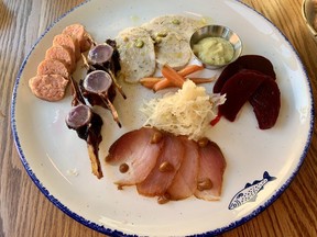 Clockwise from top left, summer salmon sausage, tuna bone marrow, cod tongue mortadella, assorted pickles, and salted tuna loin made up the charcuterie platter at Le Poisson Bleu on Somerset Street West.