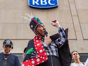 People, including Wet'suwet'en hereditary chief Na'moks, protest outside an RBC building in Montreal on May 12, 2022, due to its involvement in the Coastal GasLink pipeline project. RBC has become the focus for a number of acts of vandalism even though it is only one of 20 or so lenders to Coastal GasLink.