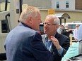 Nipissing PC candidate Vic Fedeli, right, greets Ontario PC Leader Doug Ford in North Bay on May 10, 2022.