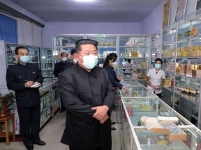 This image, taken on May 15, 2022 and released by North Korea's official Korean Central News Agency (KCNA) on May 16, shows North Korean leader Kim Jong Un (center) inspecting a pharmacy in Pyongyang.