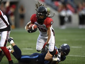 Ottawa Redblacks wide receiver Ryan Davis (15) tries to evade the tackle of Toronto Argonauts linebacker Trevor Hoyte (43) during first half of preseason CFL football action in Ottawa on Friday, May 27, 2022.