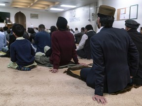 Members of Ottawa's Ahmadiyya Jama'at Muslim Community listen to their Imam Luqman Ahmed recite prayers during the celebration of Eid-ul-Fitr at the Baitul Naseer Mosque.  Felix Chagnon / Postmedia