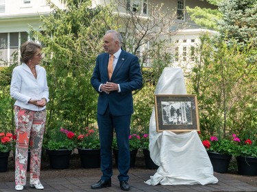 Tobi Nussbaum, the NCC's CEO, presents the new tulip bed at Stornoway to Her Royal Highness, Princess Margriet of the Netherlands. To the right stands a framed image of Princess Margriet as a newborn with her family during their time living at the Stornoway house.