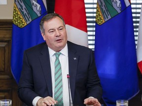 Alberta Premier Jason Kenney, left, says he will stay in the top job to maintain continuity and stability in government until a new United Conservative party leader is chosen, in Calgary, Alta., Friday, May 20, 2022.&ampnbsp;Kenney says he will not be running in the race to pick a new leader of his United Conservative party.