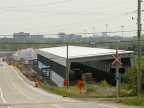 A long view of the new LRT storage and maintenance buildings being built alongside Highway 417 near Moodie Drive.