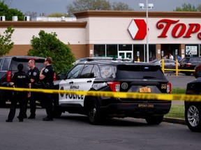 Police officers secure the scene after a shooting at TOPS supermarket in Buffalo, New York, U.S. May 14, 2022.