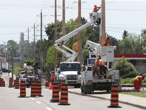 FILE Hydro workers working on power lines on Merivale Road