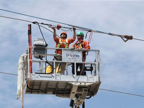 OTTAWA - May 30 2022 -  Hydro workers Cam Fisher and Zach Pearson work on some hydro lines in Nepean Monday.