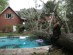 OTTAWA - May 23 2022 -  Hundreds of families from Navan were out clearing trees from their properties Monday after a storm ripped through the Ottawa area Saturday. Courtney Cameron assesses the damage of her property and house Monday in Navan.   TONY CALDWELL, Postmedia.