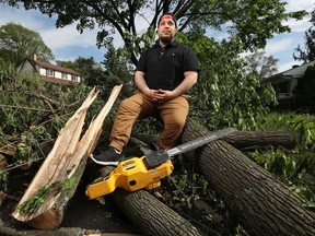 Contractor Ali Awada poses for a photo in Alta Vista Thursday afternoon. Ali took his chainsaw and his own time to go around his neighbourhood to help people cut down and clear trees which fell during the storm las Saturday.