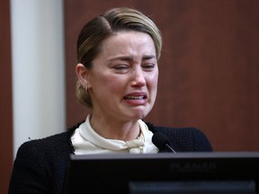 Actor Amber Heard reacts on the stand in the courtroom at Fairfax County Circuit Court during a defamation case against her by ex-husband, actor Johnny Depp, in Fairfax, Virginia, U.S., May 5, 2022.
