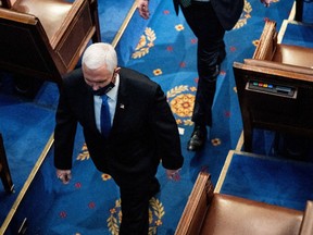 US Vice President Mike Pence evacuates from a joint session of Congress to certify the 2020 election results on Capitol Hill in Washington, U.S., January 6, 2021.