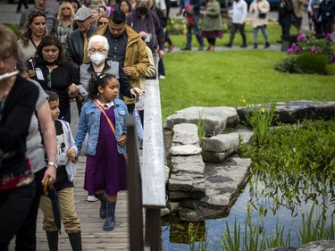 Guests make their way to the gardens in the cemetery to release their butterfly.