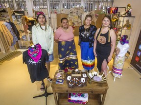 From left, Cedar Iahtail, Mbombo Malonde Kapacala, Harmony Eshkawkogan and Gabrielle Fayant prepare for Sunday's opening of Adaawewigamig, an Indigenous-owned and -operated store in the ByWard Market.