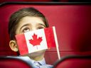 In 2020, Immigration, Refugees and Citizenship Canada (IRCC) partnered with the Ottawa Senators in a special citizenship ceremony that saw 20 families from 20 countries become Canadian citizens.  Here, seven-year-old Karam Alokel holds his flag during the ceremony.