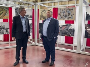 Mayor Jim Watson and former city councillor Peter Hume inside the Aberdeen Pavilion at Landsdowne Park.