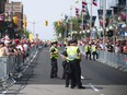 Police keep an eye on the 2016 Canada Day celebrations along Wellington St. in downtown Ottawa.