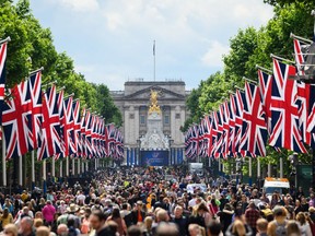 LONDON — Members of the public walk along the Mall in front of Buckingham Palace ahead of Jubilee events. The Platinum Jubilee of Elizabeth II is being celebrated from June 2 to June 4, marking the 70th anniversary of the accession of Queen Elizabeth II on Feb. 6, 1952.
