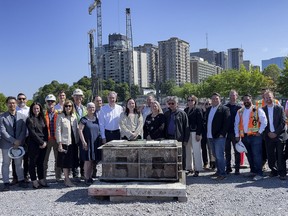 Indigenous and city political leaders joined construction and library officials to mark the setting of the foundation for Adisoke, the new Ottawa Public Library and Library and Archives Canada joint facility.