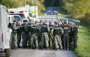 About two dozen police gather on Beck’s Road at Kinburn Side Road on Sept. 22, 2015. The scene, which saw up to 30 police vehicles at one point, was where police arrested the Wilno shooting suspect.