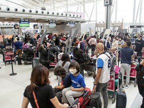 Travellers wait in line at Toronto Pearson Airport's Terminal 1.