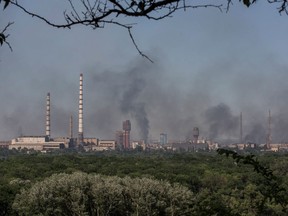 Smoke rises after a military strike on a compound of Sievierodonetsk's Azot Chemical Plant, amid Russia's attack on Ukraine, in the town of Lysychansk, Luhansk region, Ukraine June 10, 2022.