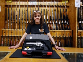 Jen Lavigne, co-owner of That Hunting Store, displays a Ruger GP100 Magnum 357, on June 3 in Ottawa.
