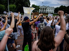 Abortion rights activists hold a moment of silence outside the White House as they protest in Washington, DC, after the U.S. Supreme Court scrapped half-century constitutional protections for the procedure.