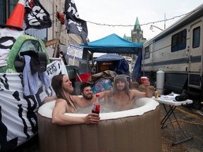 Protesters sit in a hot tub on Wellington Street, in front of Parliament Hill, during a demonstration in Ottawa.