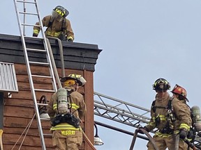 Ottawa firefighters on roof of Montana's Restaurant on Merivale Road.