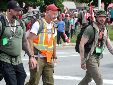 Hundreds of supporters came out to cheer on James Topp (in reflective vest) in a parking lot in Bells Corners on the final day of his cross Canada march to downtown Ottawa Thursday.
