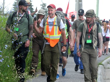 Hundreds of supporters came out to cheer on James Topp (in reflective vest) in a parking lot in Bells Corners on the final day of his cross Canada march to downtown Ottawa Thursday.