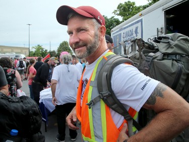 Hundreds of supporters came out to cheer on James Topp (in reflective vest) in a parking lot in Bells Corners on the final day of his cross Canada march to downtown Ottawa Thursday.