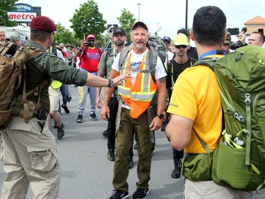 He gives a short speech to supporters, telling them to not be provoked etc. and be respectful as they marched with him.
Hundreds of supporters came out to cheer on James Topp (in reflective vest) in a parking lot in Bells Corners on the final day of his cross Canada march to downtown Ottawa Thursday.