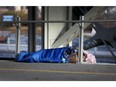 A man sleeps under the Laurier Bridge in downtown Ottawa. The city declared a housing and homelessness emergency in January 2020 but the situation has only worsened since then.