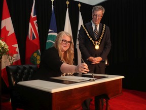 Ottawa Mayor Jim Watson presents the 'Key to the City' to Ottawa Citizen editor-in-chief Nicole MacAdam on Thursday, June 16, 2022.