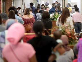 OTTAWA. JUNE 22, 2022. Some of the many people in the lineup at the passport office near Meadowlands Drive in Ottawa on Wednesday.