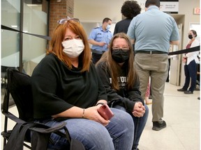 Mother and daughter Mary and Lauren Paré, 20, came prepared for a long wait at the passport office in Ottawa on Wednesday with portable chairs and water. They said they got in line at 7:30 a.m.