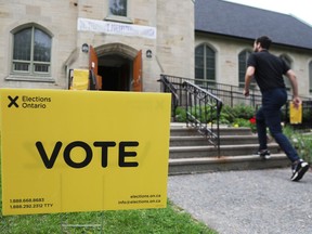 A man strides towards a polling station at St. Stephen's Presbyterian Church in Ottawa on Thursday.