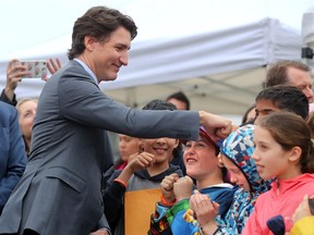 Along with other politicians and dignitaries, Prime Minister Justin Trudeau was on hand for the raising of the Pride flag on Parliament Hill Wednesday.