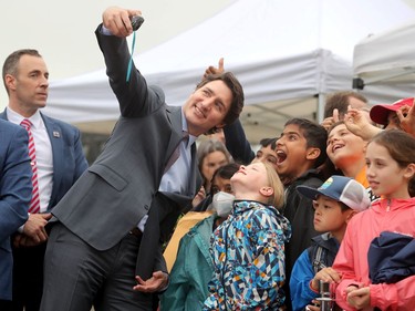 Along with other politicians and dignitaries, Prime Minister Justin Trudeau was on hand for the raising of the Pride flag on Parliament Hill Wednesday.
Ayda Rymes (front centre) and Aryan Dharamshi (rear in black) could barely contain their excitement when the PM stopped for selfies with their class from the Dearcroft Montessori school in Oakville.