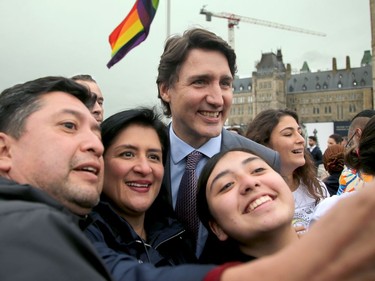 Along with other politicians and dignitaries, Prime Minister Justin Trudeau was on hand for the raising of the Pride flag on Parliament Hill Wednesday.
He stopped for selfies with the crowd following the ceremony as the flag waved proudly in the background.